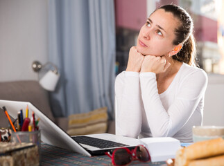 Tired woman working with laptop at the home. High quality photo