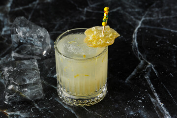 Alcoholic Scotch Whiskey Penicillin Drink Cocktail with Lemon, Honey syrup and Candied Ginger....