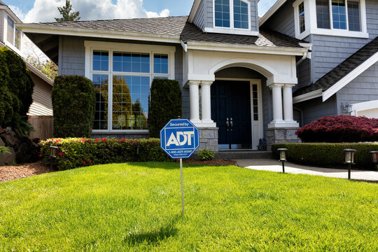 Editorial of ADT home security sign in front yard of home
