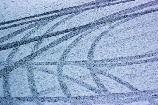 Car tire tracks in fresh snow.  Car trail pattern on slippery winter road