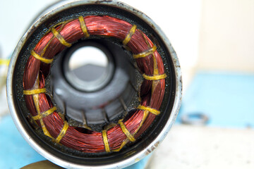 The car dynamo is awaiting repair for reuse as a source of energy in the car. Is a circle surrounded by copper, a source of electric current - obrazy, fototapety, plakaty