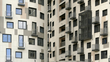 Exterior of a high-rise apartment building facade, windows and balconies.