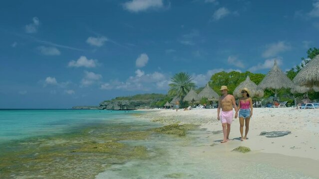  Cas Abou Beach Curacao on the caribbean island of Curacao, Playa Cas Abou in Curacao Caribbean tropical white beach with blue ocean men and woman on the beach, couple mid age on vacation