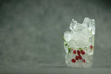 Fruit frozen inside transparent ice cube