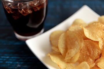 High-calorie high-calorie potato chips called mild drag placed on a blue table