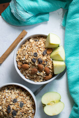 healthy breakfast cereal, bowl of cereals, oatmeal, apple, cinnamon, almonds.