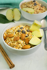 healthy breakfast cereal, bowl of cereals, oatmeal, apple, cinnamon, almonds.