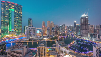 Fototapeta na wymiar Panorama of Dubai Marina with several boat and yachts parked in harbor and skyscrapers around canal aerial day to night timelapse.