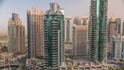 Fototapeta na wymiar Dubai Marina luxury tourist district with skyscrapers and towers around canal aerial timelapse