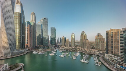 Fototapeta na wymiar Dubai marina tallest skyscrapers and yachts in harbor aerial timelapse.