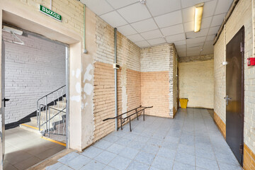 The long beige corridor with brick walls