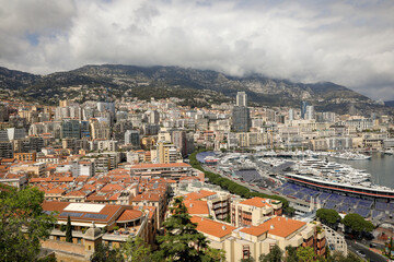 Fototapeta na wymiar Overview with the Monaco city and port during a spring sunny day with the F1 circuit construction under way.