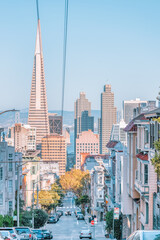 Fototapeta premium San Francisco, California, USA - October 16, 2021, descending row of stately homes on a hill, a typical neighborhood in San Francisco. Photo processed in pastel colors