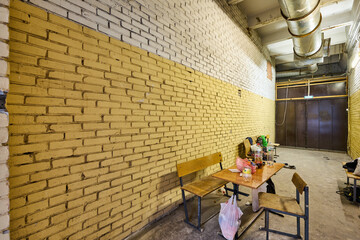 The long beige corridor with brick walls