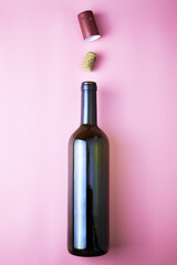 glass wine bottle stopper and shrink cap on pink background