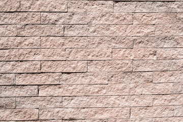 Texture of stone wall with mosaic tiles.