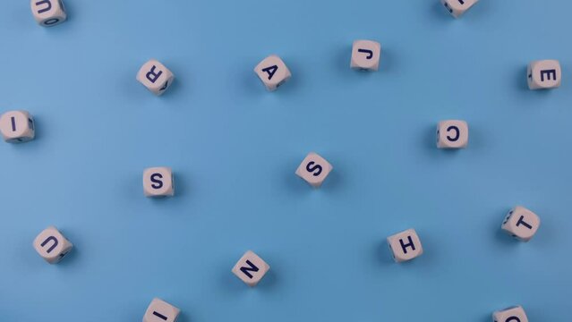 Rotating cubes or blocks word with letters randomly on a blue background - the concept of a newborn boy, school education or self education 