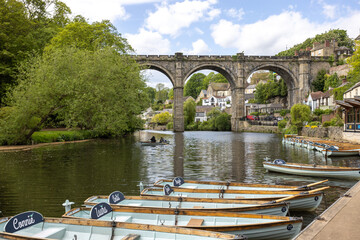 Boats on the river Nidd towards the viaduct in the town of Knaresborough in Yorkshire, UK in...