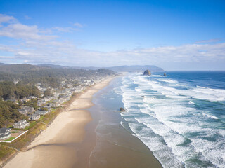 Majestic landscape - raging waves of the ocean, a long sandy beach, a small city on the ocean. A...