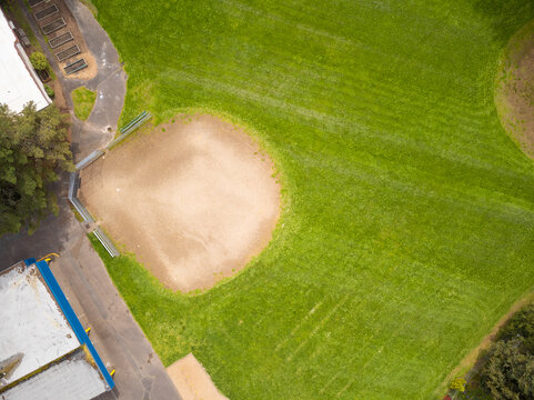 Aerial View. Green Sports Field For Playing Football, Rugby, Baseball, Golf. Sports Games, Amateur And Professional Sports, Recreation, Healthy Lifestyle. There Are No People In The Photo.