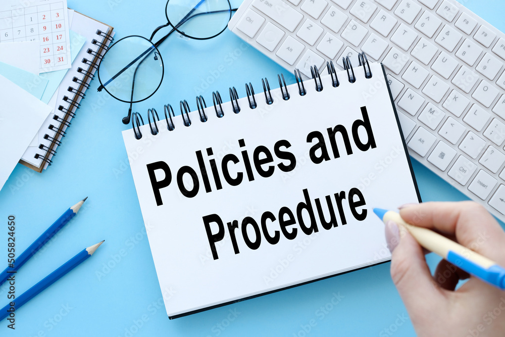 Aufkleber policies and procedures text on notepad on blue background