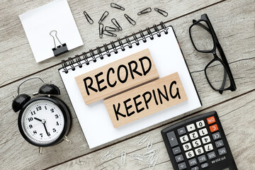 record keeping text on wooden blocks. business concept. education concept.