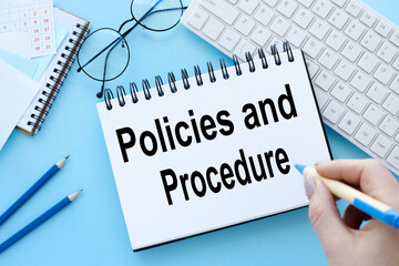Policies and Procedures text on notepad on blue background