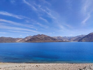 Blue reflective water of Pangong Lake in Ladakh India near Jammu at Indo-China border clear see through blue water on April 2022 lonely natural wonders on earth, Pangong Tso Lake in Ladakh 