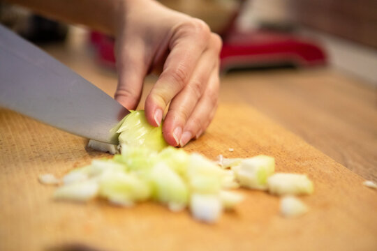 slicing onion on cut board