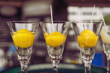 Aperitif with a mirabelle plum at a food truck. Alcoholic drink.