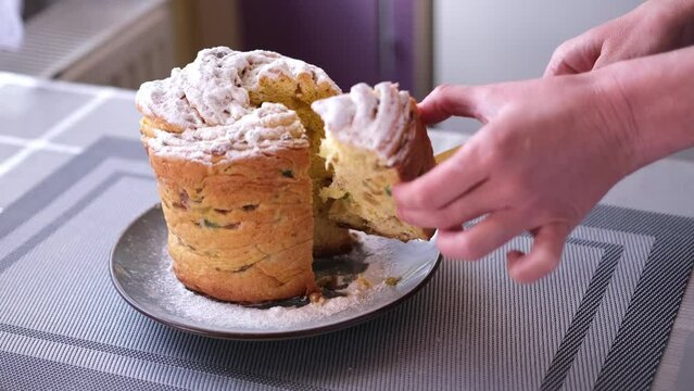 Woman taking piece of traditional Easter cruffin cake - Happy Easter concept