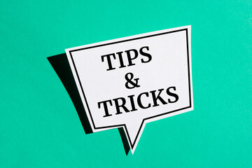 Tips And Tricks reminder speech bubble isolated on the green background.