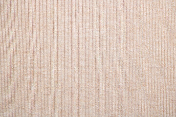 Fototapeta na wymiar Background jersey beige. Texture of delicate cream color with stripes