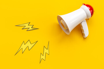 White megaphone with flying lightning. Hot news or advertising concept