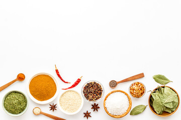 Set of colorful spices and herbs in bowls, top view