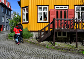 Couple walking in old part of Reykjavik, Iceland, Europe - obrazy, fototapety, plakaty