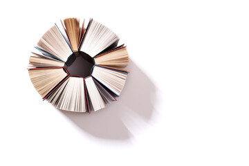 Obraz premium Several half-opened books isolated on a white background. A shadow falls on the background from the books. View from above. Copy space.