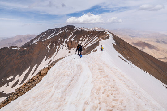 mountaineers on the ridge reaching the top Ighil M'Goun, 4,071 meters, Atlas mountain range, morocco, africa