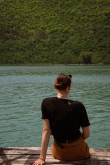 Fototapeta premium Young beautiful woman on the background of a cypress lake. Girl traveler.