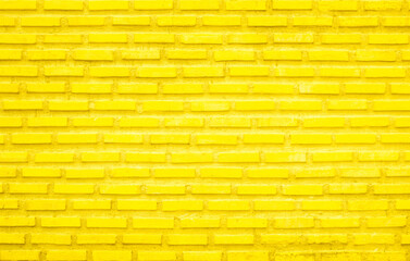 Brick wall painted with yellow paint pastel bright tone texture background. 