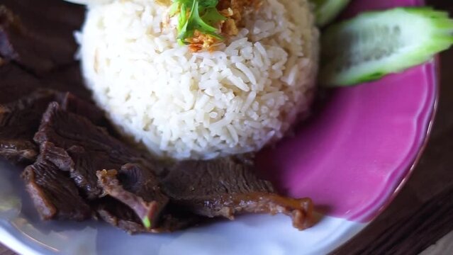 
Buffalo meat with rice. The meat is stewed and topped with rice
