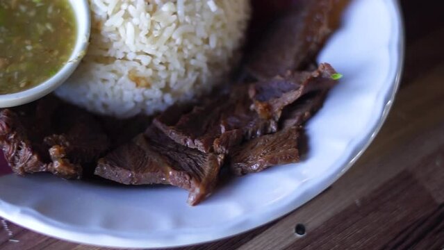 
Buffalo meat with rice. The meat is stewed and topped with rice
