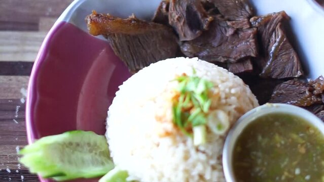 
Buffalo meat with rice. The meat is stewed and topped with rice

