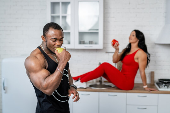 Healthy Fit Couple Eating Apples. Sportive Couple In Sportswear With Tasty Apple.