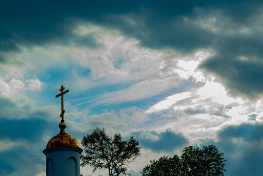 cross of the Orthodox Church on the background of a stormy sky