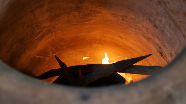 the traditional baker's tonir is heated by the fire inside. The fire from the firewood burns in the tandoor and heats the right temperature for baking the national: puri, gata, kyata, khorovats