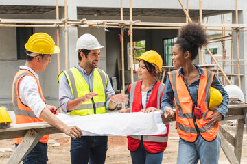 Multinational teams of male and female engineers work with a team of contractors and inspect the...