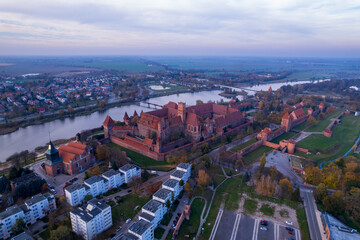 Fototapeta na wymiar Malbork. Teutonic Castle in Malbork from a drone. Pomerania, Poland. Sunset in Malbork.