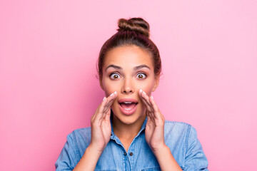 Portrait of astonished positive lady hands near open mouth say tell information isolated on pink...