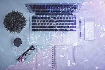 Multi exposure of forex chart drawing over table background with computer. Concept of financial research and analysis. Top view.